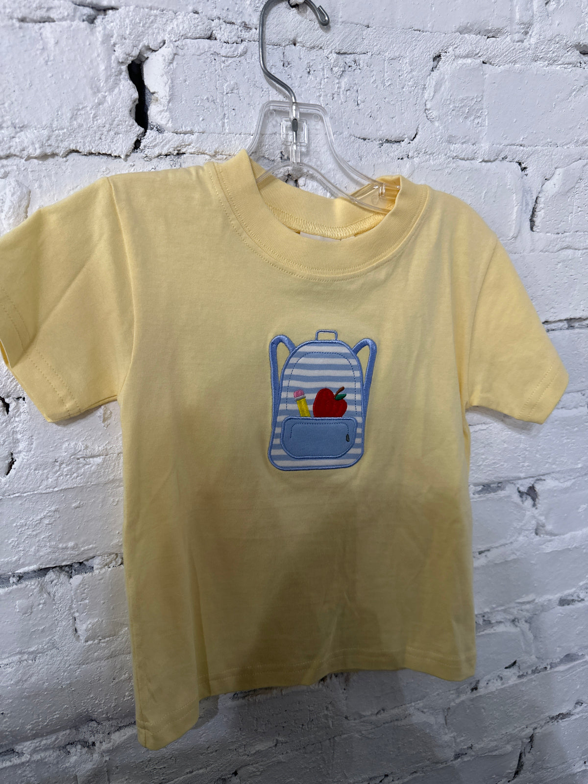 Pale yellow backpack shirt